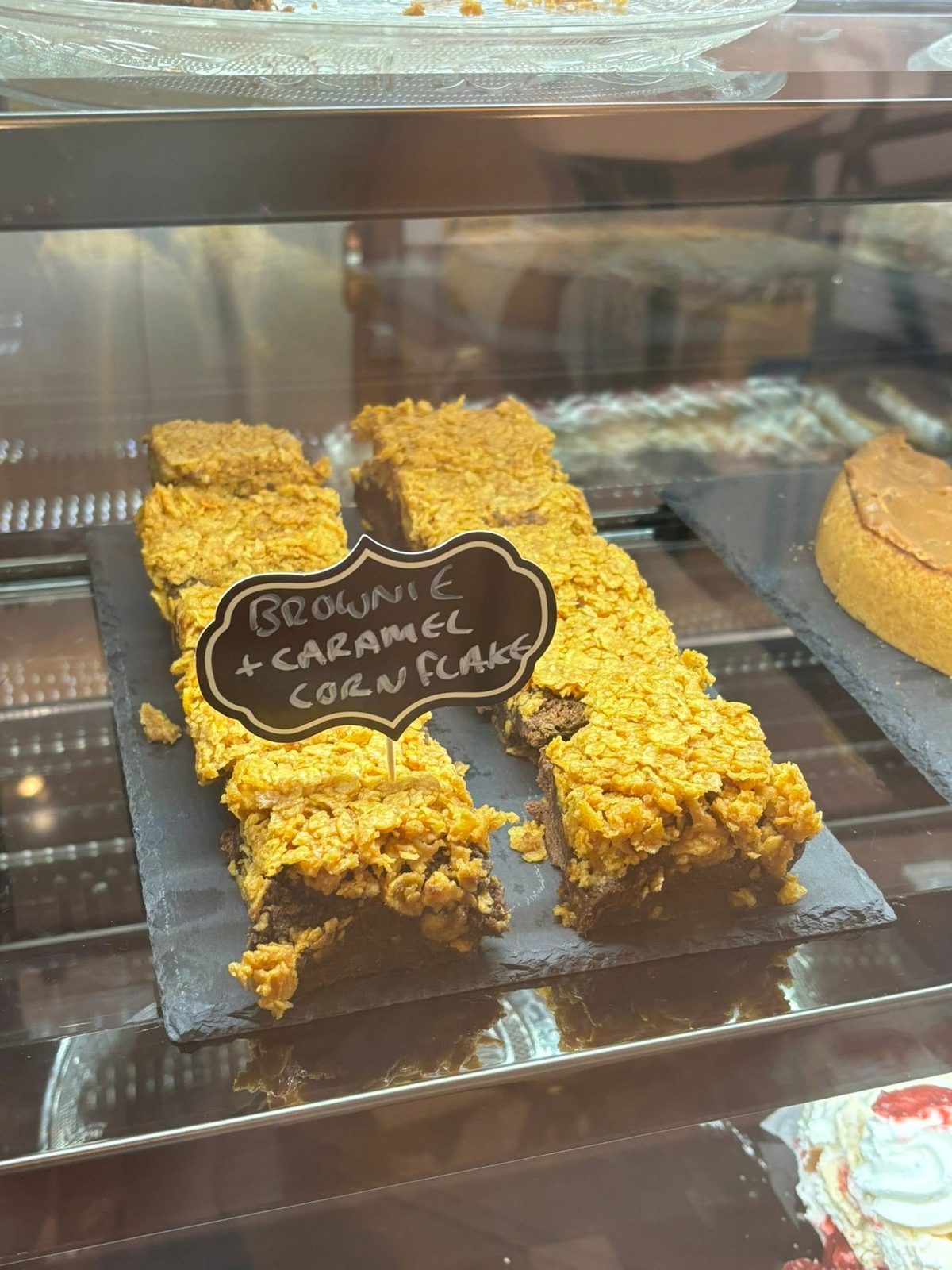 Brownie and caramel cornflake slices on a slate board