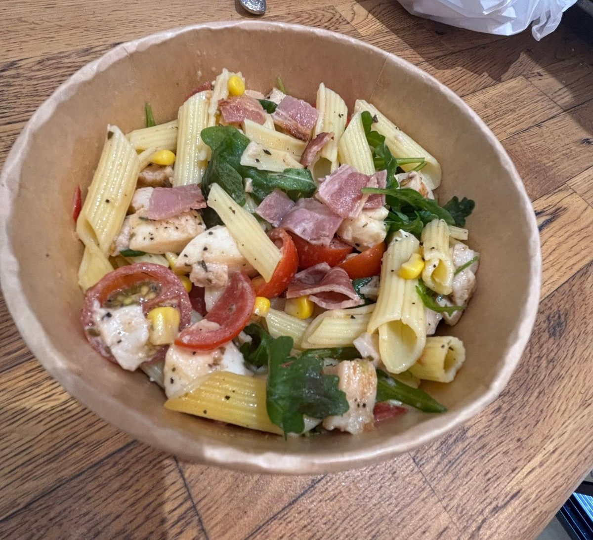 Pasta salad with chicken, ham, tomato, corn and rocket