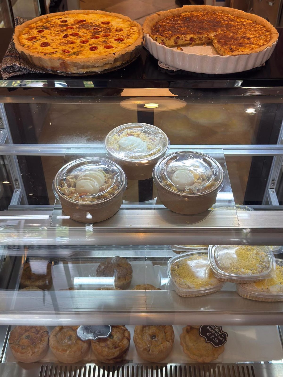 Quiches and chicken mayo pots in the display cabinet